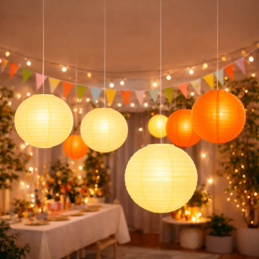 Decorative paper lanterns hanging in a festively decorated room with string lights and flags.