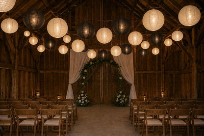 12 inch black and ivory lanterns hang for a wedding ceremony in a barn 